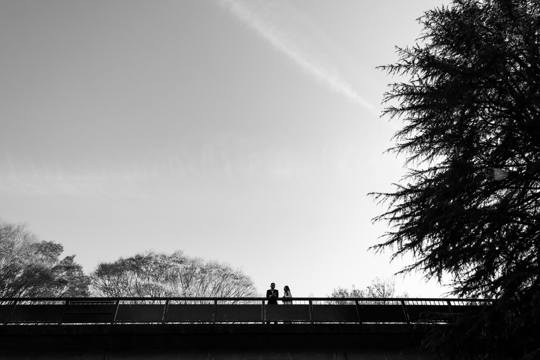 black and white portrait of couple on bridge